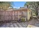 Fenced backyard with mature trees and a detached building in view at 1200 Dekalb Ave, Atlanta, GA 30307