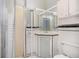 Compact bathroom featuring mosaic tile floor, corner sink, vanity, and shower with glass door at 1200 Dekalb Ave, Atlanta, GA 30307
