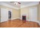 Bedroom with original hardwood floors, fireplace, white trim, and period-style details at 1200 Dekalb Ave, Atlanta, GA 30307