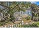 Charming home featuring a quaint picket fence, lush landscaping, and welcoming front porch at 1200 Dekalb Ave, Atlanta, GA 30307