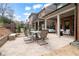 Large backyard featuring a dining area and bench seating with a patio, perfect for entertaining at 13029 Dartmore Ave, Alpharetta, GA 30005
