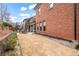 Spacious backyard featuring manicured landscaping, a dining area, and a brick home at 13029 Dartmore Ave, Alpharetta, GA 30005