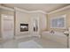 Bathroom boasting a tiled tub, and a fireplace, exuding warmth and style at 13029 Dartmore Ave, Alpharetta, GA 30005