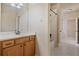 Bathroom features a single vanity with wood cabinets and a shower with a tub at 13029 Dartmore Ave, Alpharetta, GA 30005