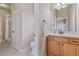 Bathroom with wood cabinets, white countertop, and a doorway leading to a shower at 13029 Dartmore Ave, Alpharetta, GA 30005