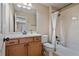 Bright bathroom featuring a single sink vanity and a shower-tub combination with white tiling at 13029 Dartmore Ave, Alpharetta, GA 30005