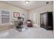Well-lit bedroom features a desk, chair, and armoire with a neutral color scheme at 13029 Dartmore Ave, Alpharetta, GA 30005
