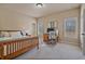 Comfortable bedroom featuring natural light, a wooden bed frame and a dedicated workspace at 13029 Dartmore Ave, Alpharetta, GA 30005