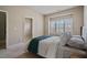 Bright bedroom with large window and neutral decor that creates a relaxing atmosphere at 13029 Dartmore Ave, Alpharetta, GA 30005