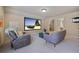 Bonus room featuring a big screen tv, comfortable seating, and a window for natural light at 13029 Dartmore Ave, Alpharetta, GA 30005
