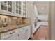 Well-appointed butlers pantry showcases white cabinetry and granite countertops at 13029 Dartmore Ave, Alpharetta, GA 30005