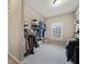 Spacious walk-in closet offering ample storage with custom shelving, and a window for natural light at 13029 Dartmore Ave, Alpharetta, GA 30005