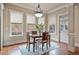 Charming dining room features natural light, hardwood floors, and stylish light fixture at 13029 Dartmore Ave, Alpharetta, GA 30005