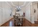 Elegant dining room features hardwood floors, decorative lighting, and detailed wall trim at 13029 Dartmore Ave, Alpharetta, GA 30005