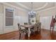 Formal dining room showcasing hardwood floors, elegant wainscoting, and stylish seating for a delightful experience at 13029 Dartmore Ave, Alpharetta, GA 30005