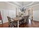 Inviting dining area with a rustic table, stylish chairs, and a decorative chandelier at 13029 Dartmore Ave, Alpharetta, GA 30005