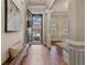 Welcoming foyer featuring hardwood floors, elegant columns, and a glimpse of the outdoors through the front door at 13029 Dartmore Ave, Alpharetta, GA 30005