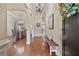 Elegant foyer with hardwood floors, detailed trim, and a view into the dining area with chandelier at 13029 Dartmore Ave, Alpharetta, GA 30005