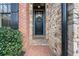 Charming front door with brick accents, stone details, and a welcoming entrance adorned with a wreath at 13029 Dartmore Ave, Alpharetta, GA 30005