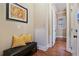 Inviting hallway with bench seat, wood floors, and access to other rooms at 13029 Dartmore Ave, Alpharetta, GA 30005