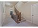Hallway featuring a staircase with wooden banisters and carpeted stairs, and access to other rooms at 13029 Dartmore Ave, Alpharetta, GA 30005