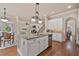Open concept kitchen with island, stainless appliances, and views of the living and dining areas at 13029 Dartmore Ave, Alpharetta, GA 30005