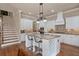Bright, open kitchen with a large island, white cabinets, and modern lighting fixtures at 13029 Dartmore Ave, Alpharetta, GA 30005