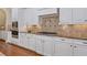 Bright kitchen features white cabinetry, granite countertops, and stainless steel appliances at 13029 Dartmore Ave, Alpharetta, GA 30005