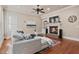 Cozy living room features a fireplace, plush sofa, and a ceiling fan at 13029 Dartmore Ave, Alpharetta, GA 30005