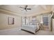Bright primary bedroom with trey ceilings, windows and neutral decor for a relaxing space at 13029 Dartmore Ave, Alpharetta, GA 30005