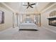 Large primary bedroom with trey ceilings, a fireplace, and windows for natural light at 13029 Dartmore Ave, Alpharetta, GA 30005