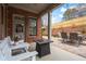 Inviting patio with a brick home, seating, outdoor table, and manicured landscaping at 13029 Dartmore Ave, Alpharetta, GA 30005