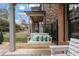 Relaxing porch swing with decorative pillows, nestled on a charming outdoor patio area at 13029 Dartmore Ave, Alpharetta, GA 30005