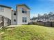 Spacious backyard with a lawn surrounded by a wooden fence at 2399 Coach Way, Jonesboro, GA 30236