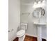 Neat powder room featuring a pedestal sink, toilet, and decorative mirror at 2399 Coach Way, Jonesboro, GA 30236