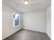 Minimalist bedroom with gray carpet, white walls and a window overlooking the neighborhood at 2399 Coach Way, Jonesboro, GA 30236