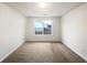 Bright bedroom featuring carpet flooring and a window view of the neighborhood at 2399 Coach Way, Jonesboro, GA 30236