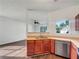 Open kitchen featuring modern appliances, laminate countertop, and hardwood floors at 2399 Coach Way, Jonesboro, GA 30236