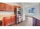 Bright kitchen featuring stainless steel refrigerator, wood cabinets, and a spacious layout with natural light at 2399 Coach Way, Jonesboro, GA 30236