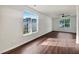 Bright living room featuring hardwood floors and large windows providing natural light at 2399 Coach Way, Jonesboro, GA 30236