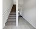 Carpeted staircase leading to the upper level, with tile flooring at the entrance at 2399 Coach Way, Jonesboro, GA 30236