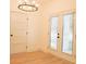 Light-filled dining room featuring wood floors, modern chandelier, and bright white trim and door at 2414 Rose Palm Pl, Atlanta, GA 30315