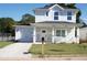 Charming two-story home with a front porch, attached garage, and newly installed driveway in a quiet neighborhood at 2414 Rose Palm Pl, Atlanta, GA 30315