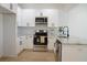 Well-lit kitchen with white cabinets, stainless steel appliances, granite countertops, and modern fixtures at 2414 Rose Palm Pl, Atlanta, GA 30315