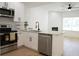 Spacious kitchen with a modern island, stainless steel appliances, and an open view into the adjacent living area at 2414 Rose Palm Pl, Atlanta, GA 30315