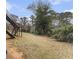 Large backyard with grassy area and mature trees, perfect for outdoor activities at 135 E Hill St # 24, Decatur, GA 30030