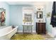 Stylish bathroom with a vintage-style clawfoot tub, vanity, and a window with natural light at 135 E Hill St # 24, Decatur, GA 30030
