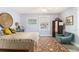Bright bedroom boasts a window, cozy seating, and a patterned rug on wood-look flooring at 135 E Hill St # 24, Decatur, GA 30030