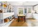 Charming dining area with a view of the kitchen, showing hardwood floors, built-in shelves, and lots of natural light at 135 E Hill St # 24, Decatur, GA 30030