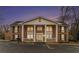 Exterior of a residential building featuring stately columns and a dusk sky, creating an inviting curb appeal at night at 135 E Hill St # 24, Decatur, GA 30030